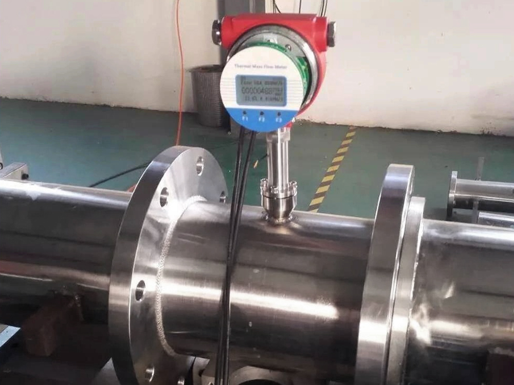 Image showing on-site maintenance and calibration of a PokcenserTech thermal mass flow meter in a high-temperature gas line.